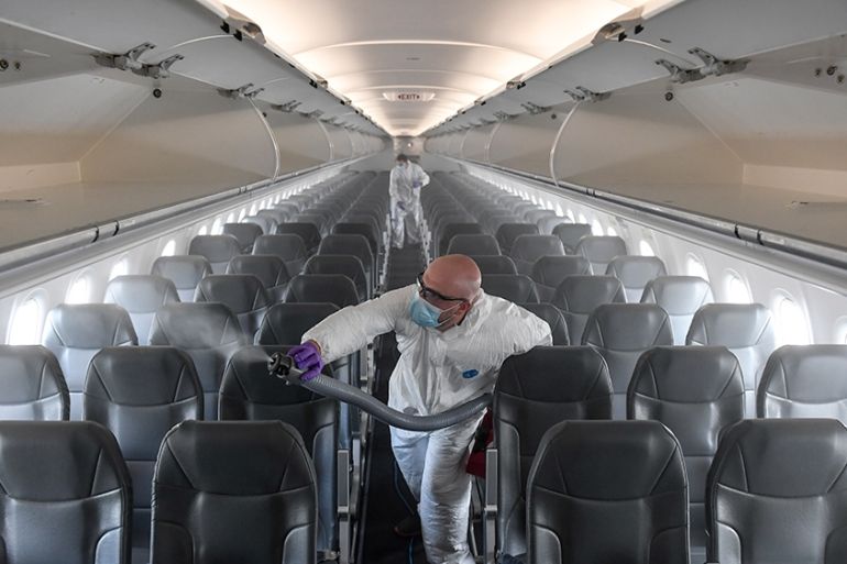 DENVER, CO - MAY 6: Brandon Wilson, owner of AvidJet, disinfects a Frontier airplane with a fogger at Denver International Airport on Tuesday, May 6, 2020. ProShield, the microbiostatic agent used to