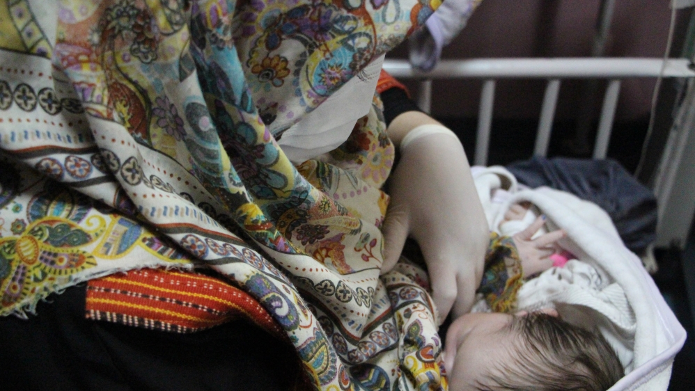 Newborn infants receive medical care in Kabul