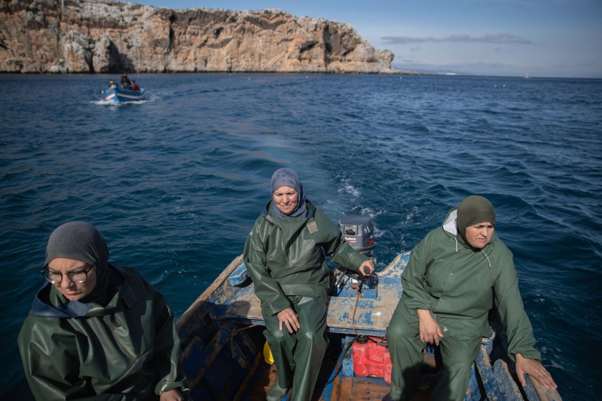 In this Wednesday, Feb. 12, 2020 photo, Fatiha Naji, right, Fatima Mekhnas, center and Saida Fetouh, left, members of the first Moroccan female fishing cooperative go out to sea in a fishing boat, in