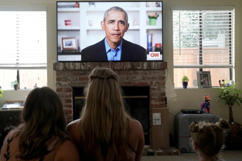 Torrey Pines High School graduating student Phoebe Seip (18, center), and her sisters Sydney (22, left) and Paisley, 6, watch former U.S. President Barack Obama deliver a virtual commencement address
