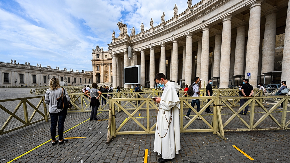 People line up in respect of security distancing to access St. Peter's Basilica on May 18, 2020 in The Vatican during the lockdown aimed at curbing the spread of the COVID-19 infection, caused by the 