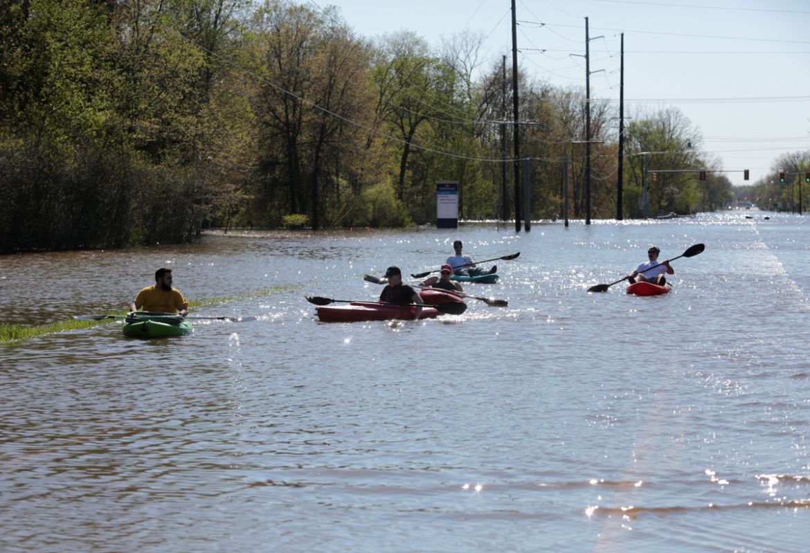 Residents paddle kayaks along a flooded street along the Tittabawassee River, after two dam failures submerged parts of Midland, Michigan, U.S., May 20, 2020. REUTERS/Rebecca Cook