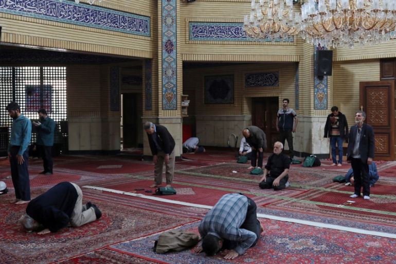 Iranian worshippers pray individually at a mosque, following the outbreak of coronavirus, in Tehran