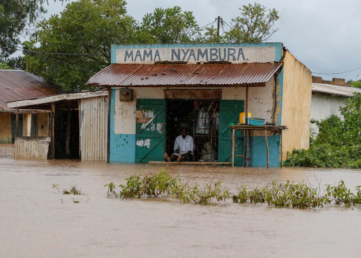 A trader sits at his shop as he looks at the food waters, after River Nzoia burst its banks and due to the backflow from Lake Victoria, in Buyuku village of Budalangi, in Busia County, Kenya May 2, 20