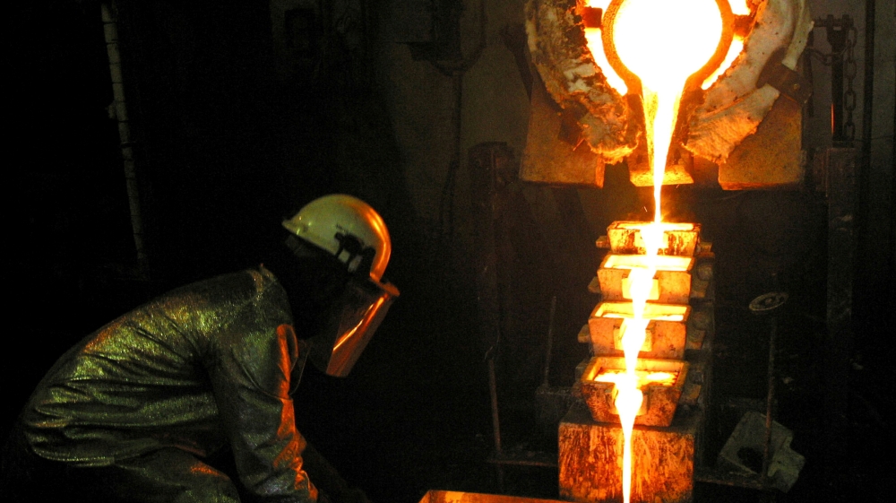 A worker pours gold at the AngloGold Ashanti mine at Obuasi, Ghana