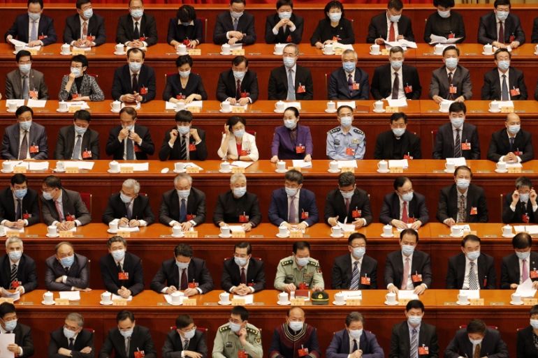 Delegates wearing face masks to protect against the spread of the new coronavirus wait for the start of the opening session of the Chinese People''s Political Consultative Conference (CPPCC) at the Gre