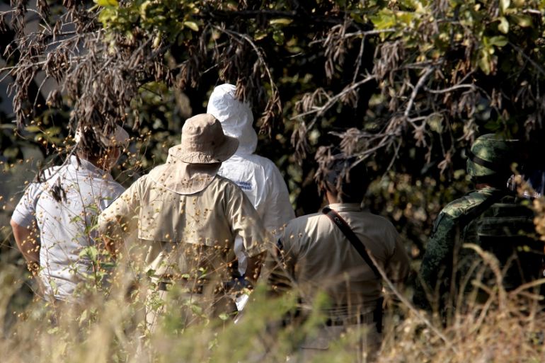Soldiers, forensic personnel and prosecutors work in the area where a clandestine mass grave was discovered at Lomas del Vergel in the community of Zapopan, Jalisco state, Mexico, on January 16, 2020.