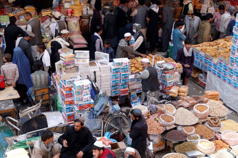 People shop for festive goods in preparation for Eid al-Fitr, marking the end of the fasting month of Ramadan amid the spread of the coronavirus disease (COVID-19), in Kabul