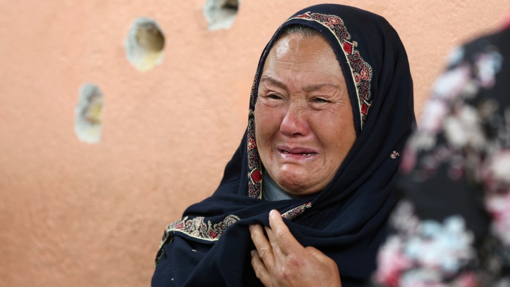 An Afghan woman cries