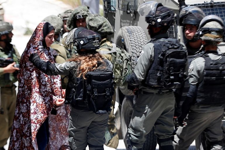 A Palestinian woman cries as she is stopped by Israeli forces after an Israeli soldier was killed by a rock thrown during an arrest raid, in Yabad near Jenin in the Israeli-occupied West Bank May 12,