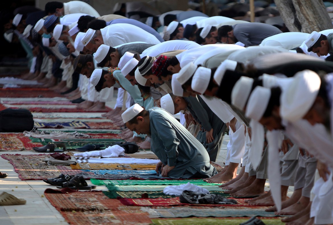Muslims offer Eid al-Fitr prayer at an open area in Peshawar, Pakistan, Sunday, May 24, 2020. Millions of Muslims across the world are marking a muted and gloomy holiday of Eid al-Fitr, the end of the
