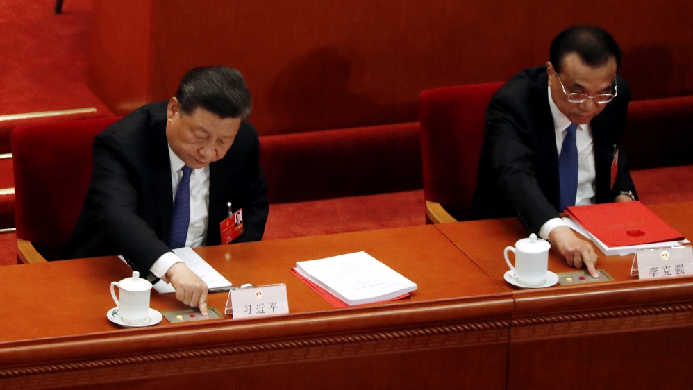 Chinese President Xi Jinping and Premier Li Keqiang cast their votes on the national security legislation for Hong Kong Special Administrative Region at the closing session of NPC in Beijing