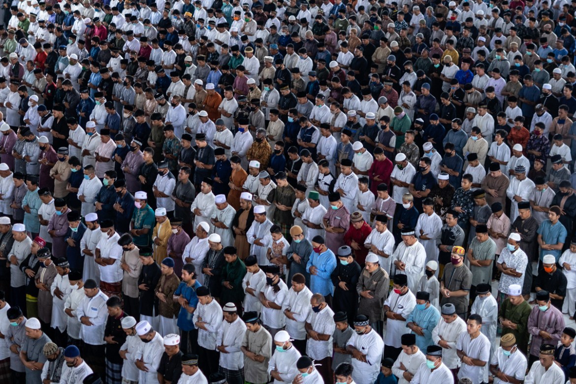 Muslim men perform an Eid al-Fitr prayer despite concerns of the new coronavirus outbreak, at a mosque in Lhokseumawe in the deeply conservative Aceh province, Indonesia, Sunday, May 24, 2020. Million