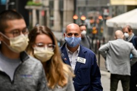 A trader walks in front of the New York Stock Exchange (NYSE) on May 26, 2020 at Wall Street in New York City. Wall Street stocks surged early May 26, 2020 on optimism about coronavirus vaccines as th