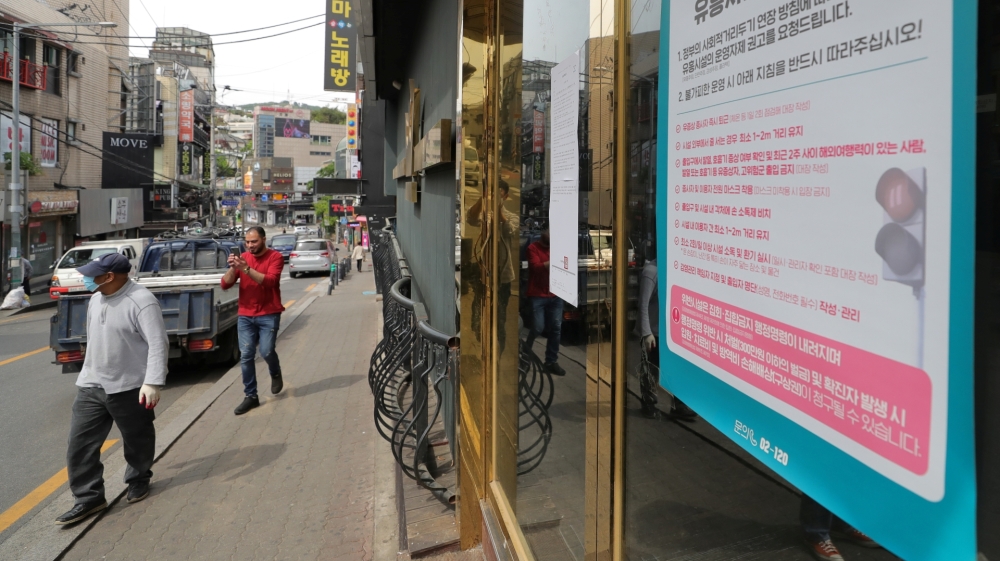 A list of precautions to prevent the spread of the coronavirus disease (COVID-19) is seen at an entrance of a club in Seoul