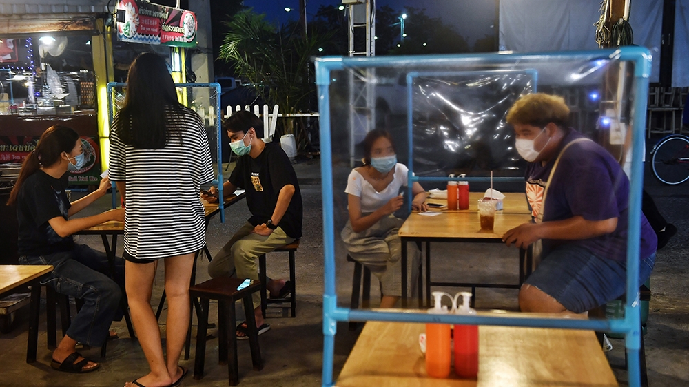 This picture taken on May 22, 2020 shows people eating at tables with plastic dividers, as a preventive measure against the spread of the COVID-19 novel coronavirus, at the Srinagarindra Train Night M