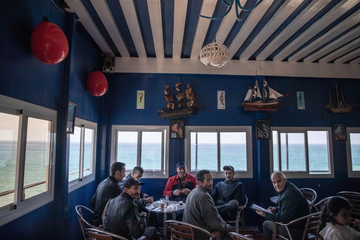 In this Tuesday, Feb. 11, 2020 photo, fishermen hang out in a coffee shop in the village of Belyounech, where the the first Moroccan female fishing cooperative was started, on the coast of the Mediter
