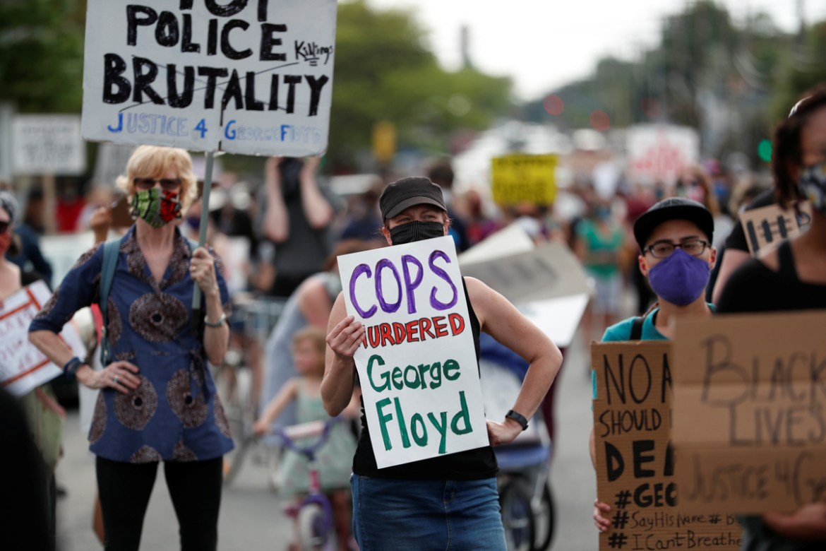 Protesters gather at the scene where George Floyd, an unarmed black man, was pinned down by a police officer kneeling on his neck before later dying in hospital in Minneapolis, Minnesota, U.S. May 26,