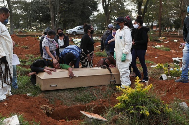 Relatives react during the burial of 64-year-old Raimunda Conceicao Souza, who died from the coronavirus disease (COVID-19), at Vila Formosa cemetery, Brazil''s biggest cemetery, in Sao Paulo, Brazil
