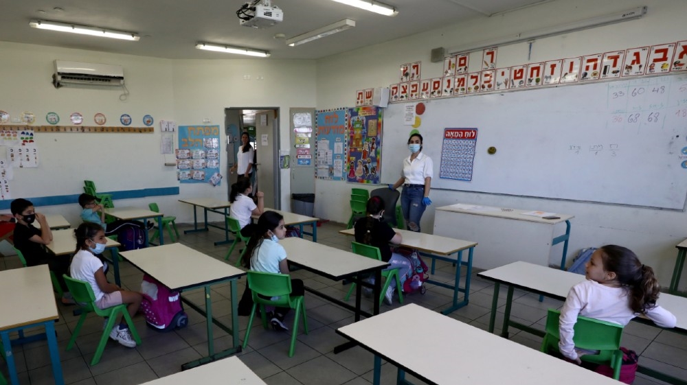 Students sit in classroom at their elementary school as it reopens following the ease of restrictions preventing the spread of the coronavirus disease (COVID-19), 