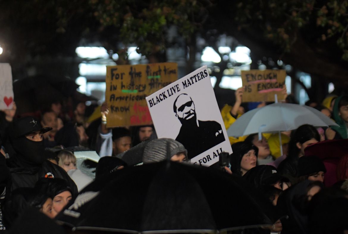 New Zealand protesters hold a vigil against the killing of Minneapolis man George Floyd in a Black Lives Matter protest outisde Parliament in Wellington on June 1, 2020. (Photo by David Lintott / AFP)