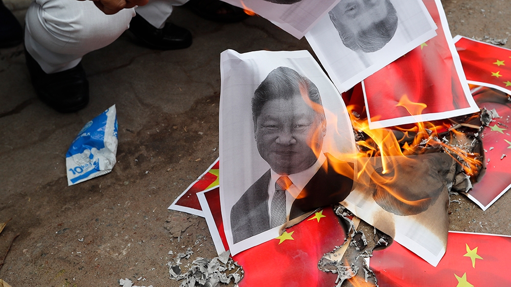 Indians burn photographs of Chinese President Xi Jinping during a protest against the Chinese government in Lucknow , India , Wednesday, June 17, 2020. As some commentators clamored for revenge, India