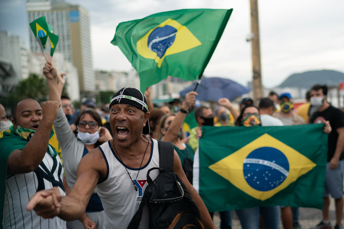 A demonstrator shouts slogans during a protest in support of Brazil's President Jair Bolsonaro at Copacabana beach in Rio de Janeiro, Brazil, Sunday, June 7, 2020. (AP Photo/Leo Correa)