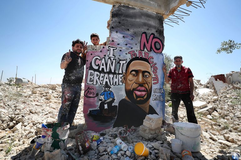 Syrian artists Aziz Asmar and Anis Hamdoun finish a mural depicting George Floyd, an unarmed African-American man who died while while being arrested and pinned to the ground by the knee of a Minneapo
