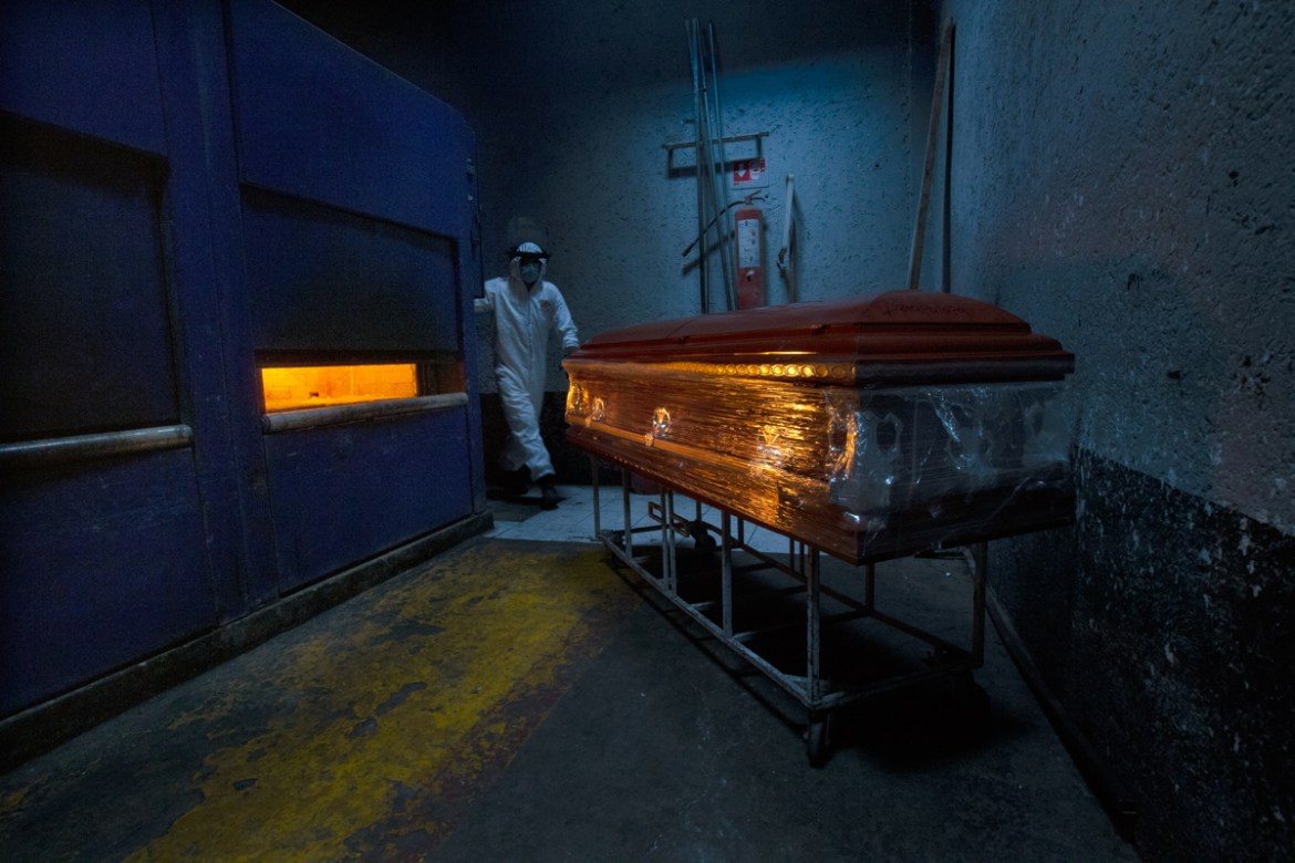 A crematorium worker prepares an oven for a COVID-19 victim at the Panteón de San Nicolás Tolentino cemetery in the Iztapalapa neighborhood of Mexico City, Thursday, June 4, 2020. Funeral parlors and