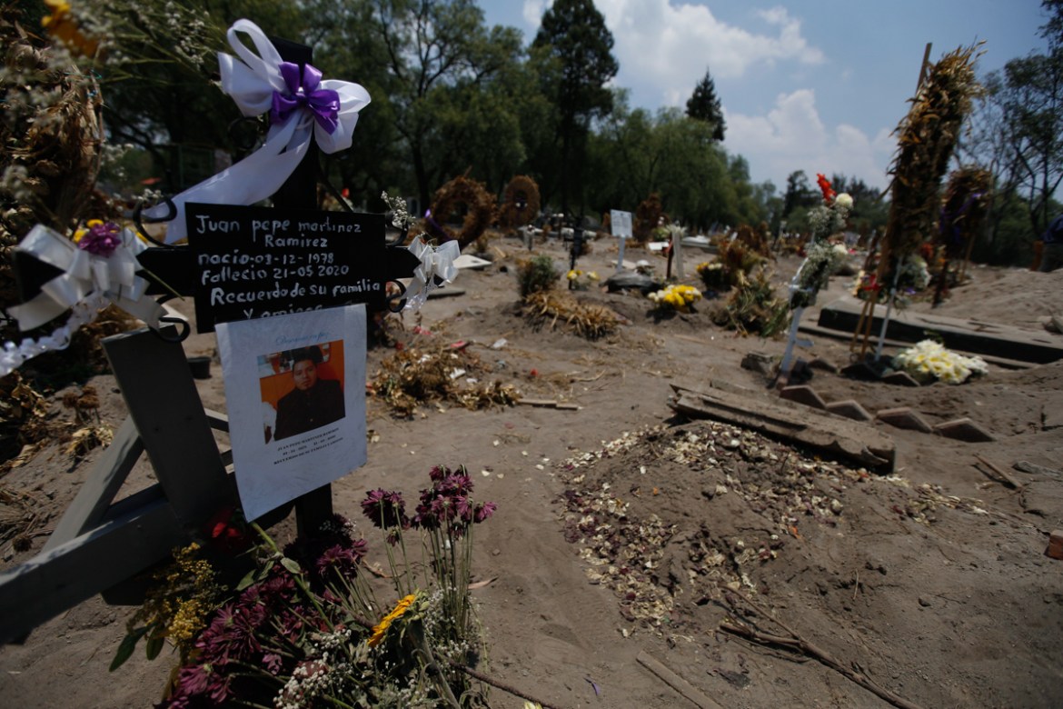 A sign marks the gravesite of Juan Pepe Martinez Ramirez, who was born on Dec. 1, 1978 and died on May 21, 2020, in a section of the San Lorenzo Tezonco Iztapalapa cemetery reserved for COVID-19 victi