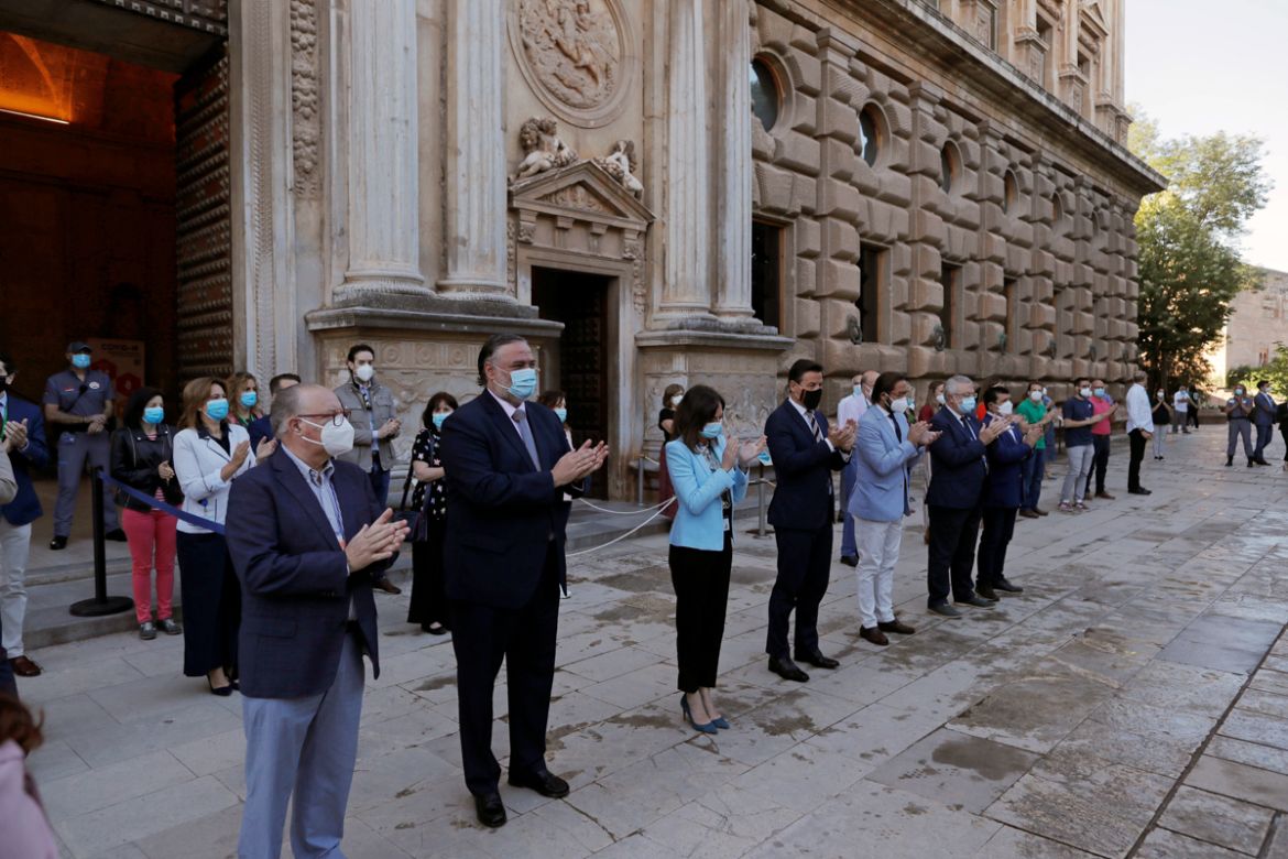 Authorities and staff clap as they commemorate the people who died of COVID-19, as the Alhambra palace reopens to the public under strict social distancing measures, after being closed on March 13 ami