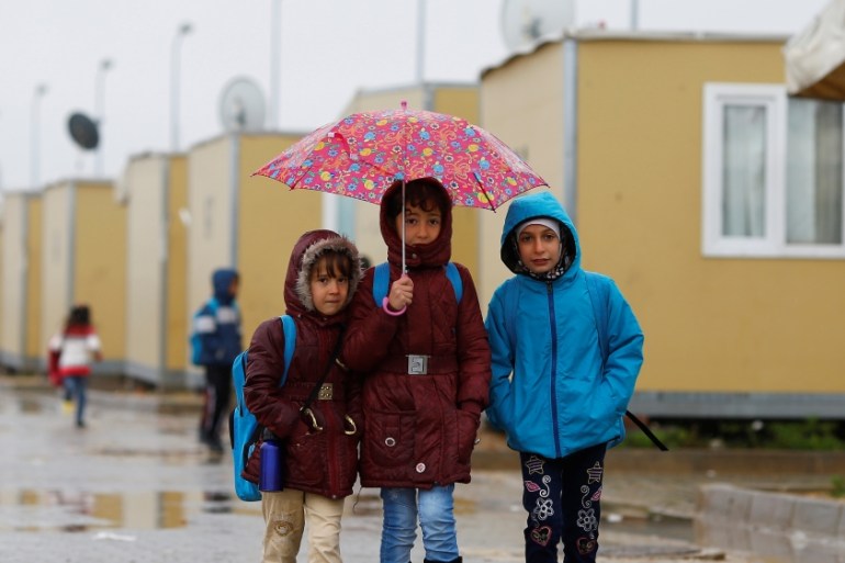Syrian refugee children walk in Elbeyli refugee camp