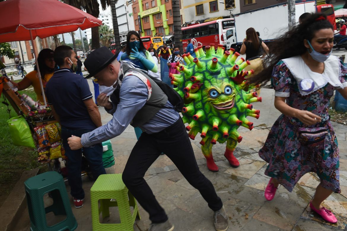 Artist perform at the Botero square, as part of an awareness campaign to stop the spread of the COVID-19 coronavirus, in Medellin on June 10, 2020. (Photo by JOAQUIN SARMIENTO / AFP)