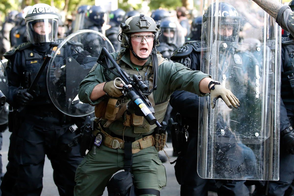 Police begin to clear demonstrators gathered as they protest the death of George Floyd, Monday, June 1, 2020, near the White House in Washington. Floyd died after being restrained by Minneapolis polic