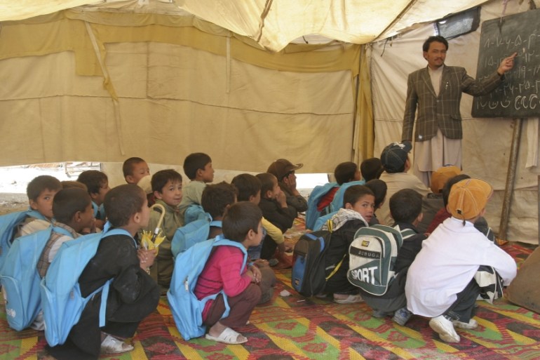 Afghan children study in a school in Ghazni province