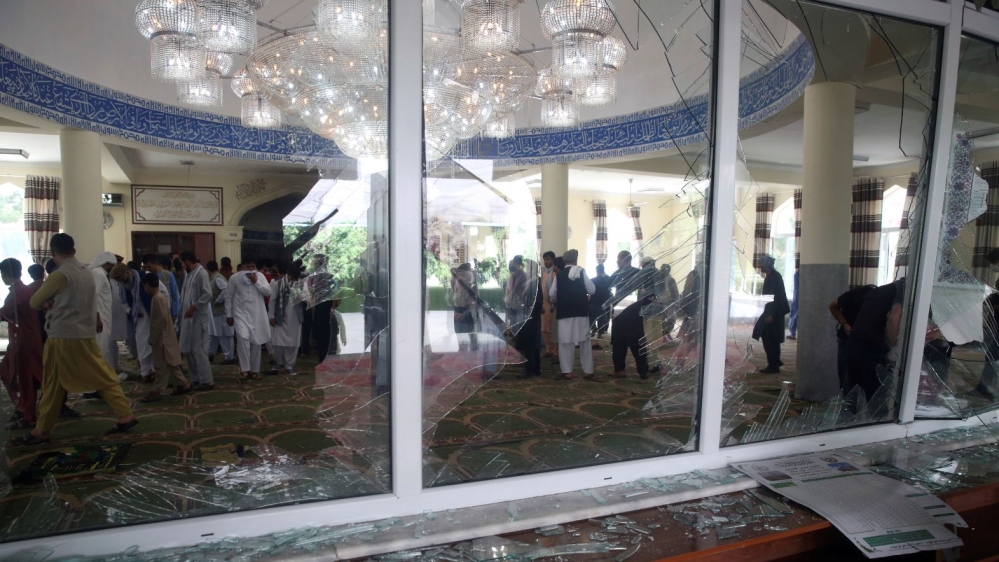 Afghans inspect the inside of a mosque following a bombing, in Kabul, Afghanistan, Friday, June 12, 2020.