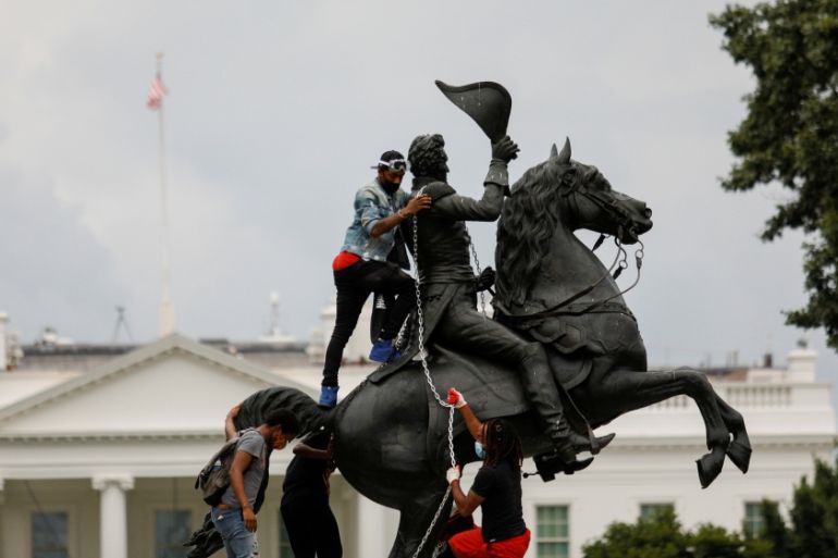 Protestors attach a chain to the statue of U.S. President Andrew Jackson in front of the White House in an attempt to pull it down in Washington