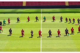 Liverpool players take a knee in memory of George Floyd at Anfield on June 01, 2020 in Liverpool, England.