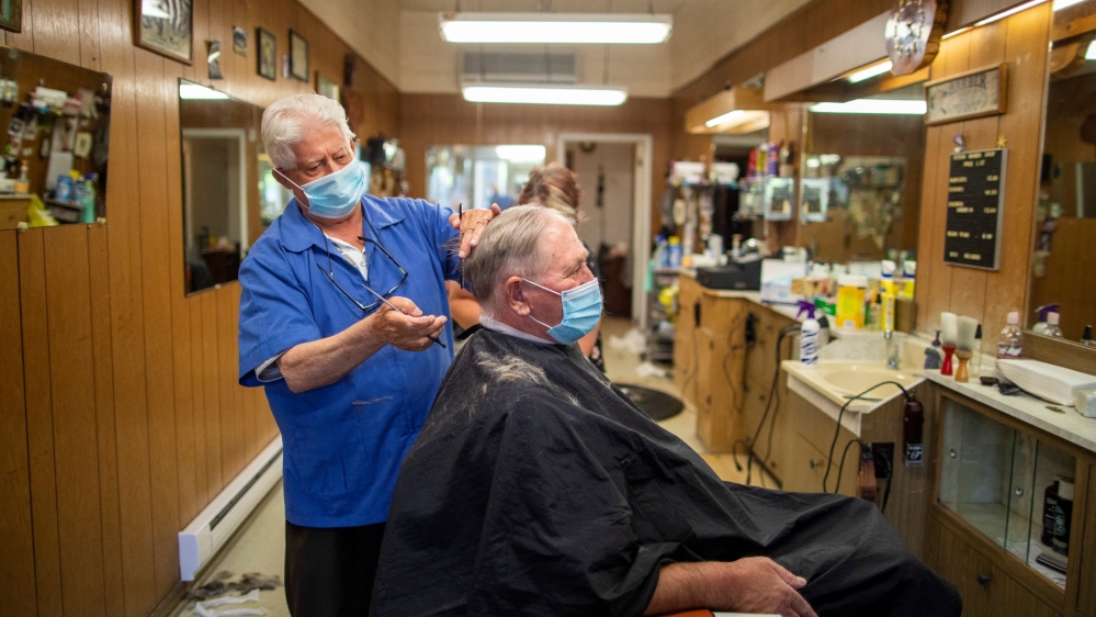 Peter Bosciglio cuts Joe Krywionek's hair at Peter's Barbershop as the provincial phase 2 reopening from the coronavirus disease (COVID-19) r