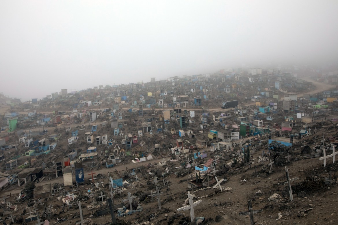 A funeral home vehicle carrying COVID-19 victims drives through the Nueva Esperanza cemetery on the outskirts of Lima, Peru, Tuesday, May 26, 2020. (AP Photo/Rodrigo Abd)