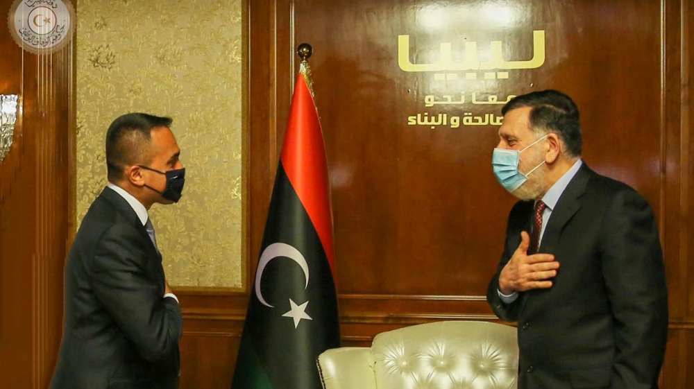 Prime Minister Fayez al-Serraj of Libya's internationally recognised Government of National Accord (GNA) wears a protective mask as he meets with Italian Foreign Minister Luigi Di Maio in Tripoli