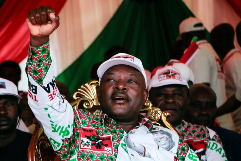 Burundi’s incumbent president Pierre Nkurunziza raises his fist as he reacts to supporters during the last campaign rally of the candidate of the ruling party the National Council for the Defense of D
