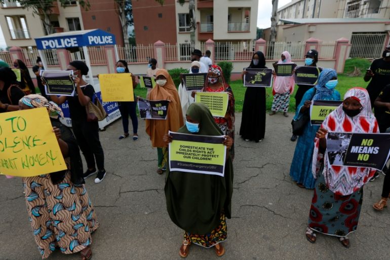 Protesters carry banners as they stage a demonstration to raise awareness about sexual violence in Abuja