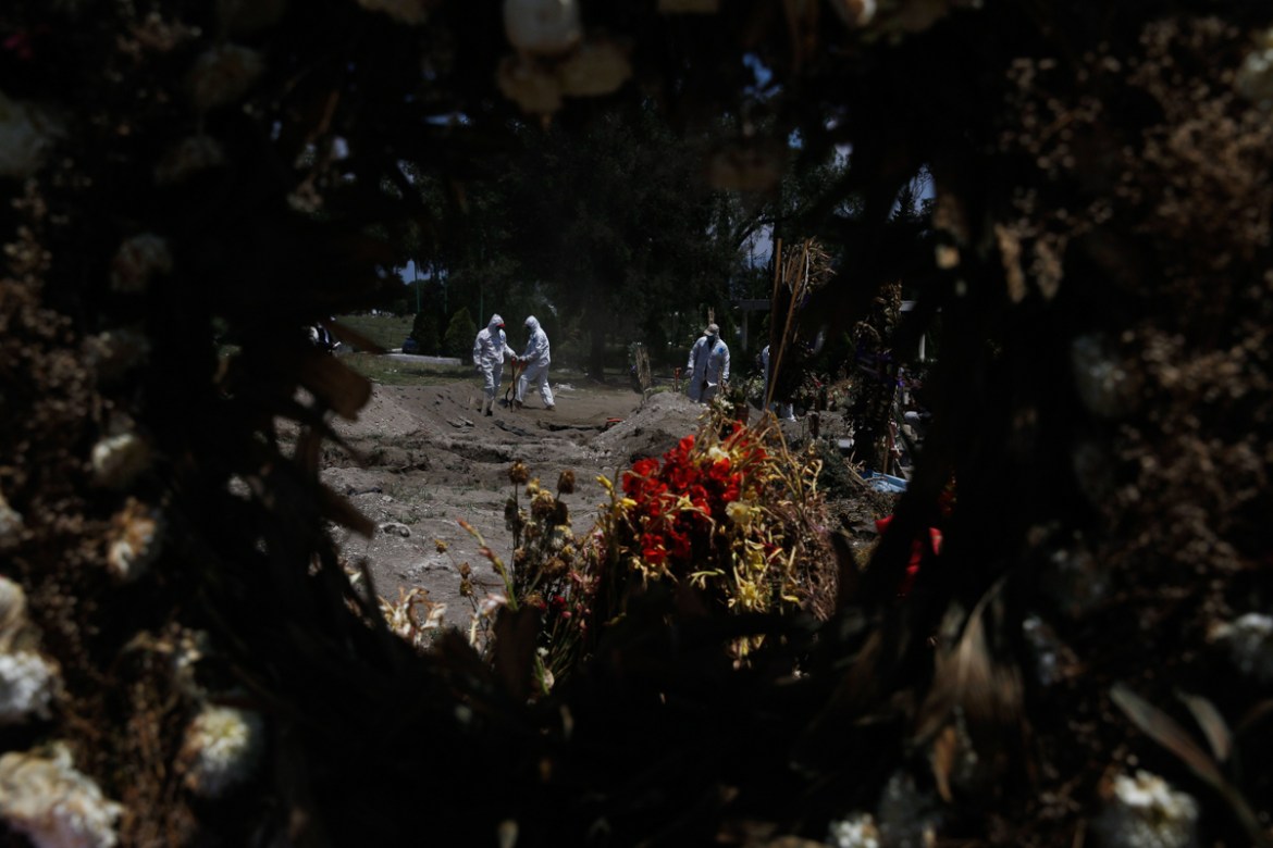 Cemetery workers in a protective gear bury COVID-19 victims at the Panteón de San Lorenzo Tezonco Iztapalapa cemetery in a section reserved for people who died of the new coronavirus in the Iztapalapa