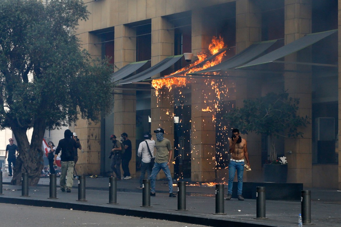Anti-government protesters burn awnings of the Le Gray hotel during ongoing protests against the Lebanese government, in downtown Beirut, Lebanon, Saturday, June 6, 2020. Hundreds of Lebanese demonstr