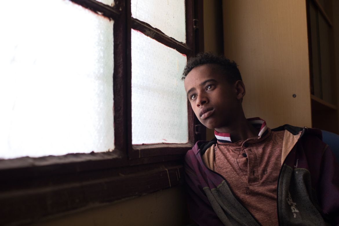 Firomsa waits at a community centre for Ethiopian migrants in Hargeisa, Somaliland. The 15-year-old arrived in the country with his younger brother Buhari (14). The two were persuaded by friends to le