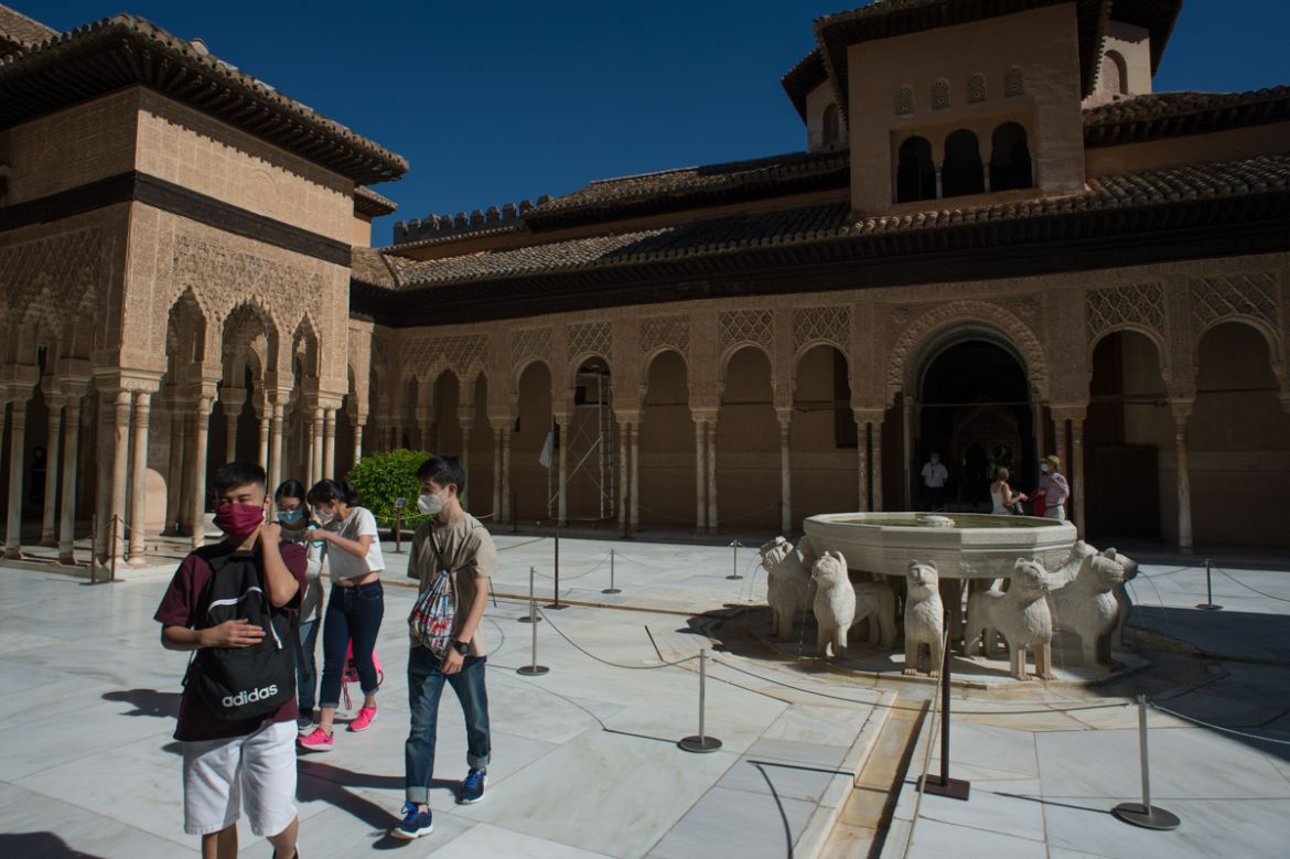 Tourists visit the Court of the Lions (Patio de los Leones) at the Alhambra in Granada on June 17, 2020, on the day it reopens to the public after three months of closure due to the coronavirus pandem
