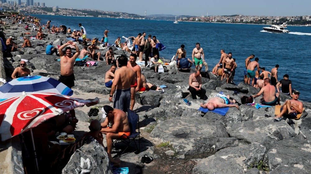 Men enjoy a sunny weather by the Marmara Sea following the coronavirus disease (COVID-19) outbreak, in Istanbul, Turkey, June 7, 2020. REUTERS/Murad Sezer -