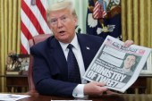 US President Donald Trump showing a copy of the New York Post before signing an executive order on social media companies at the White House on May 28, 2020 [File: Jonathan Ernst/Reuters]