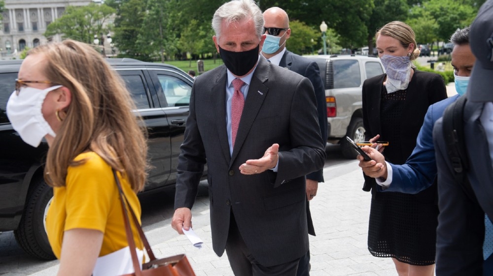 US House Minority Leader Kevin McCarthy, Republican of California, wears a mask as he leaves following a press conference about Republican efforts against House